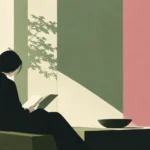 Woman reading a book in a green armchair with shadows of leaves on the wall